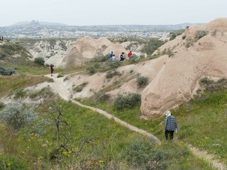 Tourists walking hiking exploring path trail cappadocia turkey rock formations
