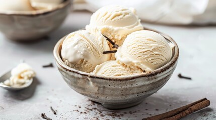 Fototapeta premium Vanilla ice cream in a bowl on a table with a light backdrop