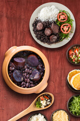 Traditional Brazilian feijoada with a red background