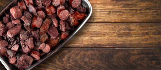 Traditional Brazilian feijoada with a wooden background