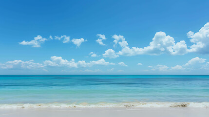 Obraz premium Amazing view of a beautiful beach with turquoise water and white sand. Clear blue sky with white clouds. Relaxing and peaceful scene.