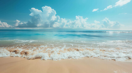 Amazing view of the beach with white sand and blue ocean. The sun is shining brightly and there are white clouds in the sky.