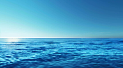 Deep blue ocean. The surface of the water is calm and still. The sky is clear and blue. The horizon is distant and meets the water in a perfect line.