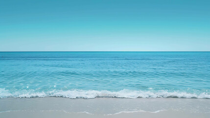 The image is of a beautiful beach with white sand and clear blue water. The sky is a bright blue and the sun is shining.