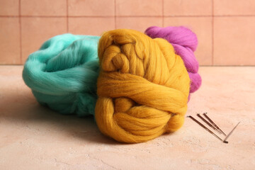 Set of wool for felting with needles on color background