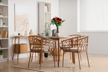 Dahlia flowers in vase on dining table in room
