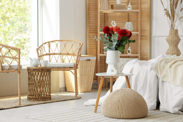 Dahlia flowers in vase on coffee table in interior of stylish bedroom
