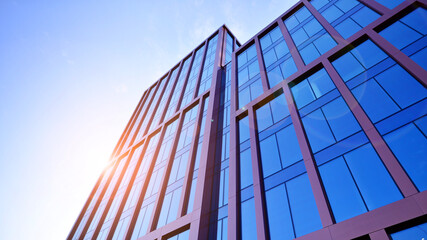 Modern stylish architecture. Symmetrical blue glass building in the city. Cityscape office buildings with modern corporate architecture - business and success concept.
