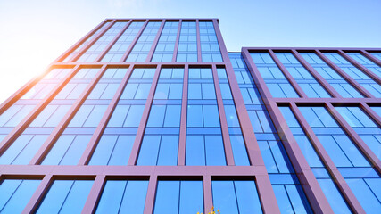 Modern stylish architecture. Symmetrical blue glass building in the city. Cityscape office buildings with modern corporate architecture - business and success concept.