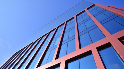 Modern stylish architecture. Symmetrical blue glass building in the city. Cityscape office...