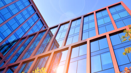 Modern stylish architecture. Symmetrical blue glass building in the city. Cityscape office...