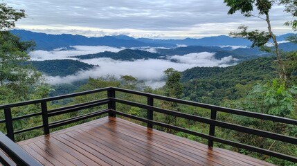 Fototapeta premium Experience breathtaking green mountains from a balcony in Northern Thailand, where clouds and mist create a serene atmosphere in the hills below