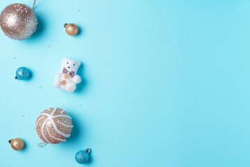 Blue background with balls and Christmas decoration. Flat lay, top view. Copy space