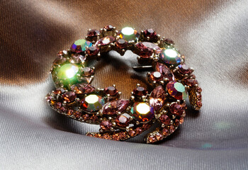 Antique brooch with multi-colored glass in the shape of precious stones, made in Germany