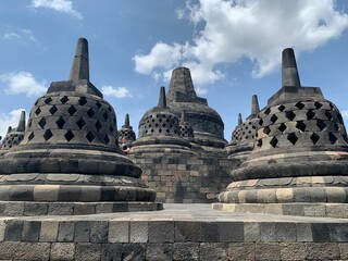 Borobudur Temple with ancient stupas and blue sky.