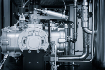 A close up of a black engine with a white part. The engine is a large piece of machinery