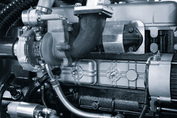 A close up of a black engine with a white part. The engine is a large piece of machinery