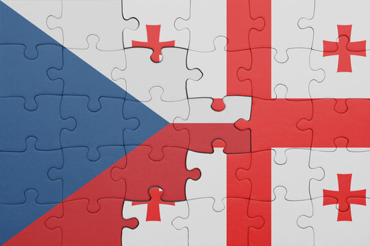 puzzle with the colourful national flag of czech republic and flag of georgia .