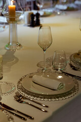 Beautiful table setting, for a holiday. with the dishes .flowers and candles