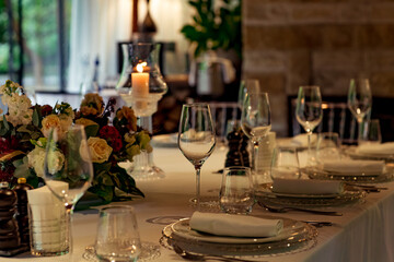 Beautiful table setting, for a holiday. with the dishes .flowers and candles