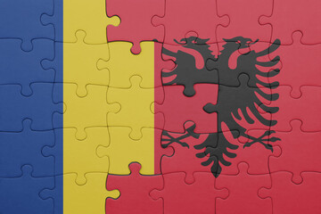 puzzle with the colourful national flag of romania and flag of albania .