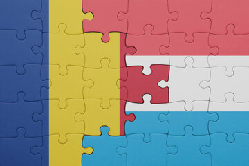 puzzle with the colourful national flag of romania and flag of luxembourg .