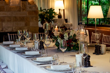 Beautiful table setting, for a holiday. with the dishes .flowers and candles