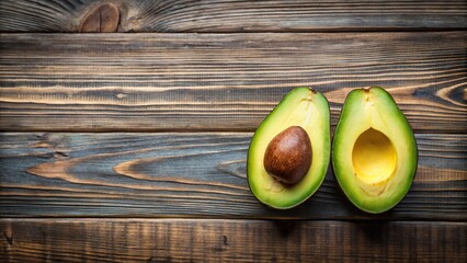 Minimalist avocado cut in half with leaves on wooden surface