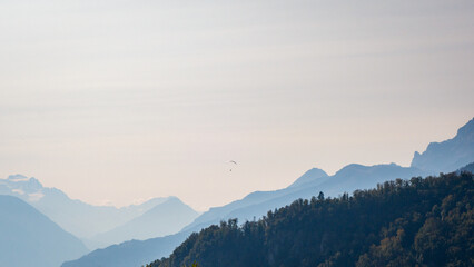 Paraglider flying over the Swiss Alps