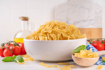 Raw Mafaldine pasta with ingredient for cooking