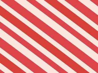 Obraz premium A simple, abstract background features a repeating pattern of red and white diagonal stripes, creating a classic and festive design.