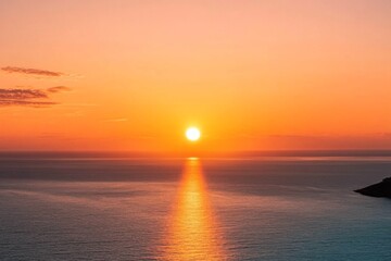 Fototapeta premium Stunning sunset photograph capturing an orange sky over the sea, with the sun gracefully setting on the horizon, showcasing a beautiful seascape view from above.