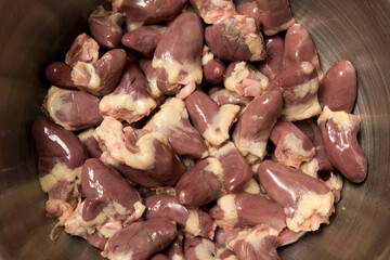 Raw chicken hearts piled together, showing texture and freshness. Popular ingredient in traditional and pet food recipes.