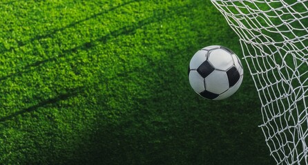 Obraz premium Soccer ball flying into the goal, captured in a close-up, top-down perspective on green grass using Sony Alpha A9 II and Sony FE 20-60mm f/4-5.6 G OSS lens for a hyper-realistic, ultra-detailed view.