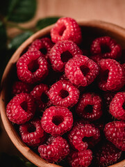 Fresh Raspberries: Juicy, Ripe Berries for a Healthy Summer Snack on a Wooden Background