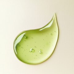 Green gel swatch with tiny bubbles on a light beige background. Aloe vera or green tea shower gel texture.