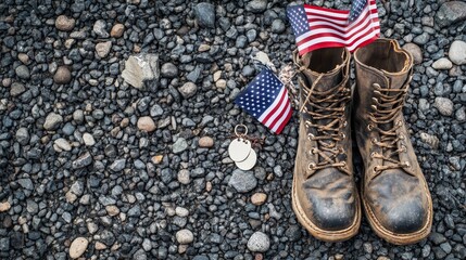 Worn Military Boots with American Flags and Dog Tags on Gravel