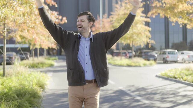 Cheerful Man Celebrates Career Success Outdoors