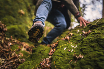 close up of the sole of a boot descend around greenery forest