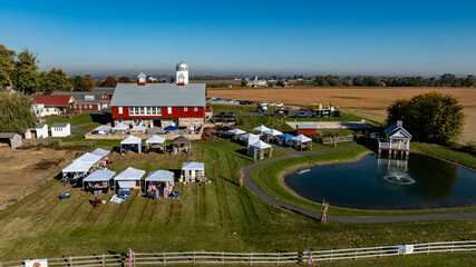 A large red barn with a white roof sits on a farm © Greg Kelton