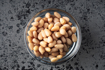 Shelled Pine Nuts: Close-Up of Roasted Siberian Seeds on Black Background
