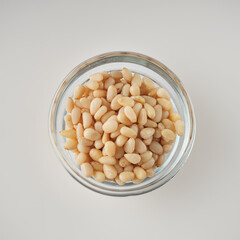 Shelled Pine Nuts: Close-Up of Roasted Siberian Seeds on a White Background