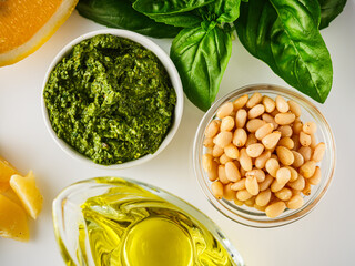 Homemade Pesto Sauce with Pine Nuts and Basil: Ingredients on White Background