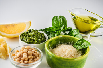 Homemade Pesto Sauce with Pine Nuts and Basil: Ingredients on White Background