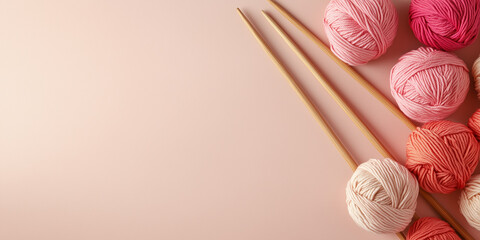 Delicate banner with space for text for knitting related topics and yarn shops, pink balls of yarn and wooden knitting needles on light background