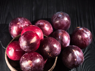 Juicy Summer Plums: Fresh Red and Black Plums on a Rustic Wooden Background