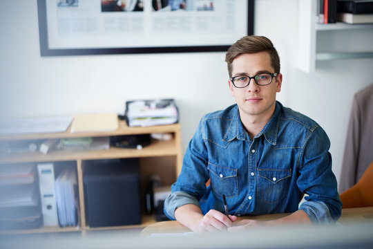 Creative, intern and portrait of business man in office for administration, designer and startup. Planning, product merchandiser and schedule with person and writing in agency for entrepreneur