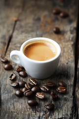 Coffee Cup with Roasted Beans on Rustic Wooden Table