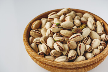 Fresh Pistachios: Nutritious Green Nuts on a White Background