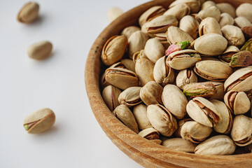 Fresh Pistachios: Nutritious Green Nuts on a White Background